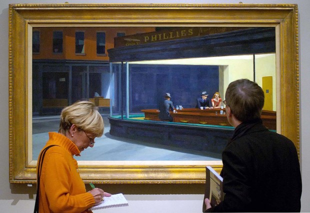 Two visitors contemplate the painting 