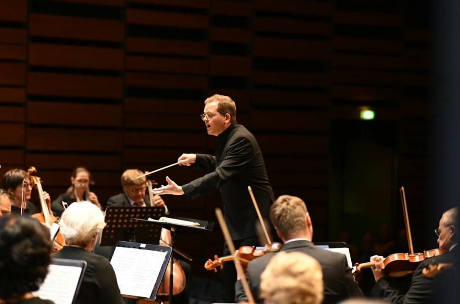 Orchestra and Conductor During the Performance