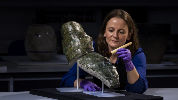 WEB Conservator Bethan Bryan with the Roman arm guard.