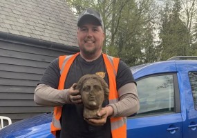 Greg Crawley Holding the Head of the Statue