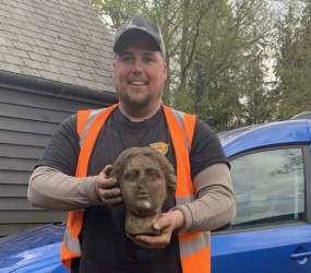 Greg Crawley Holding the Head of the Statue